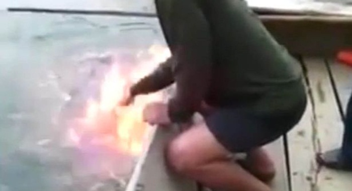 Ultra-polluted-lake-bursts-into-flames-as-shocked-fisherman-puts-hand-in-water