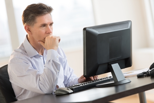 Businessman Working On Desktop Pc In Office