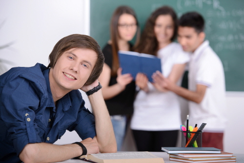 Group young students while studying in classroom