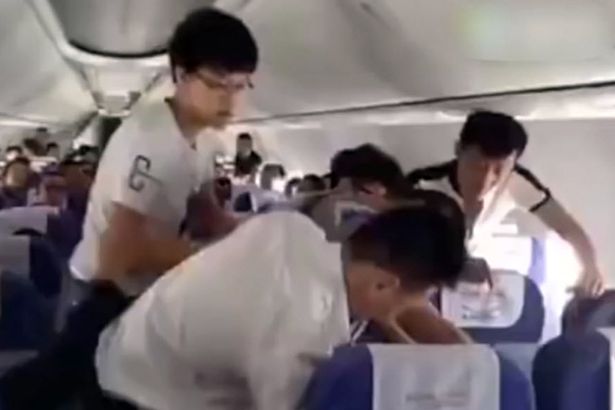 PAY-Other-passengers-attempt-to-hold-the-angry-man-down