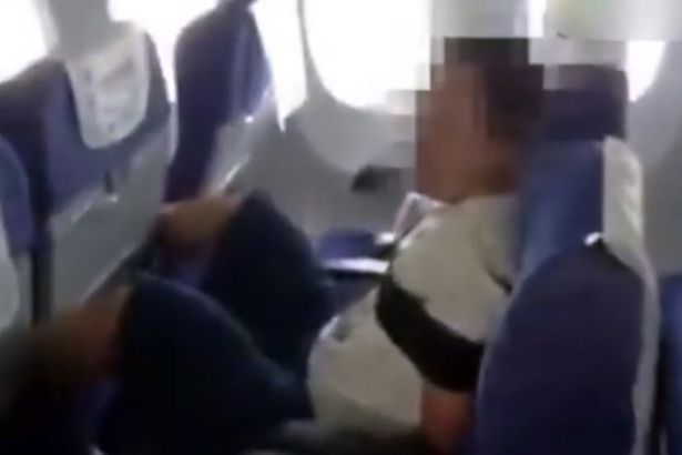 PAY-Passenger-with-his-hands-tied-behind-his-back