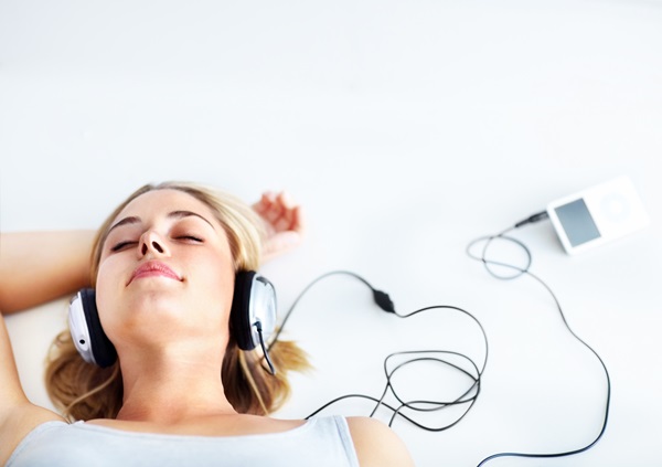 Beautiful young lady sleeping while listening to music