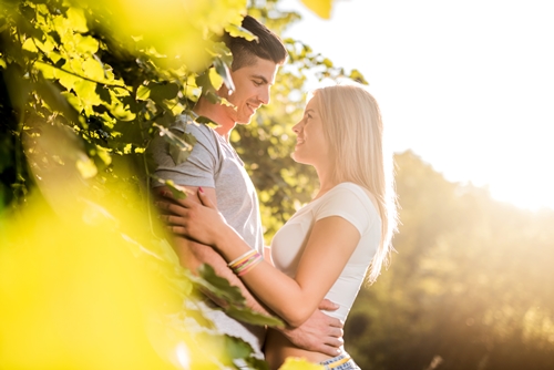 Young loving couple talking to each other in nature.