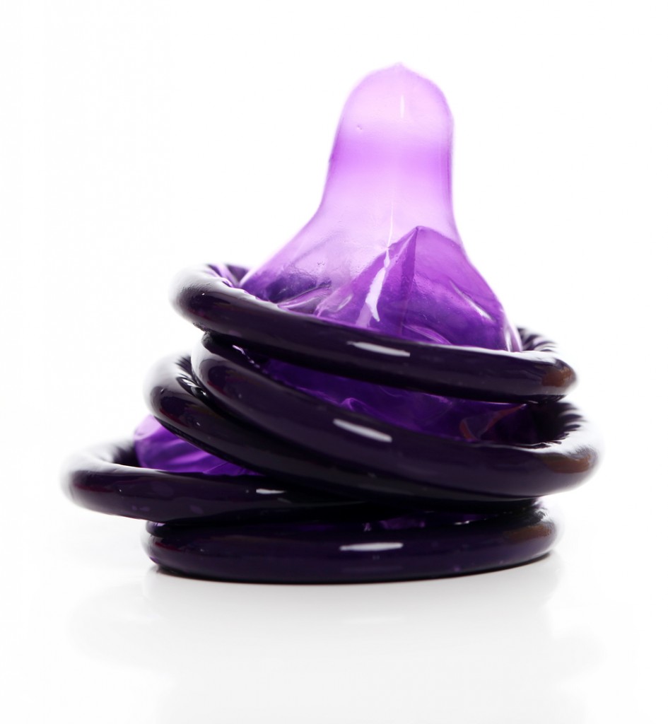 Violet condoms isolated over background