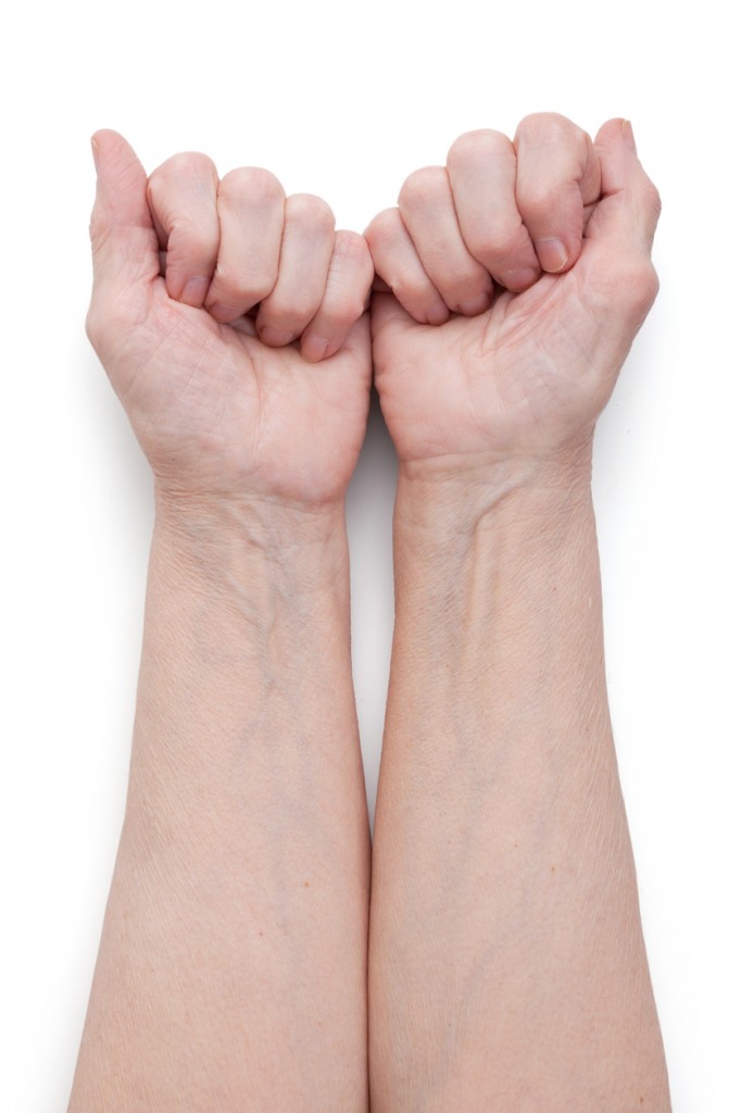 Hands of an elderly man, short of a fist