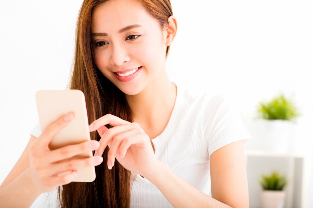 young beautiful woman reading message with smart phone