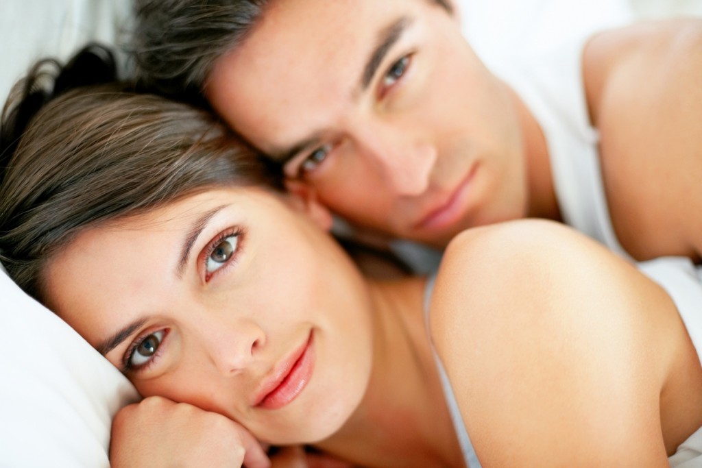 Romantic young couple relaxing in bed