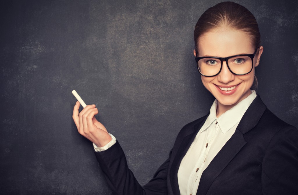 business woman teacher with glasses and chalk