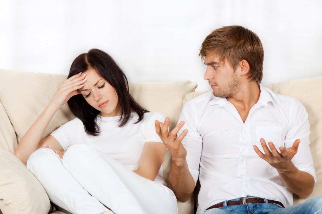 Couple sitting on couch at home