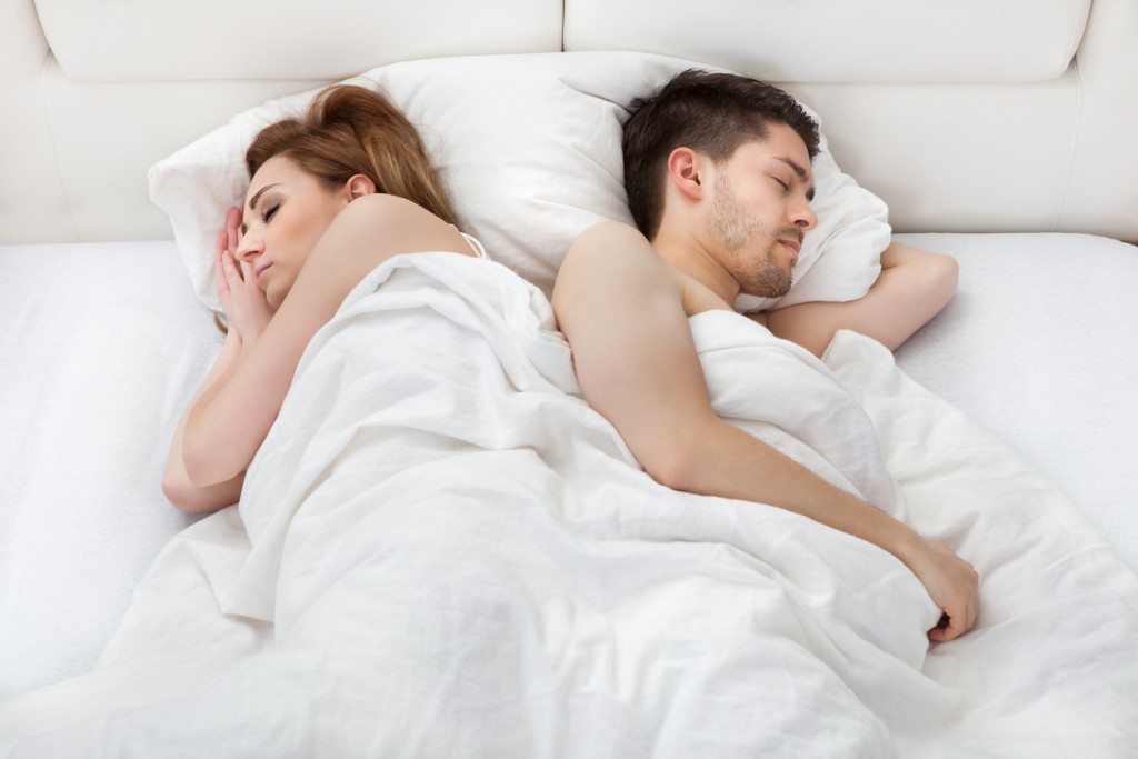 Young couple sleeping on bed