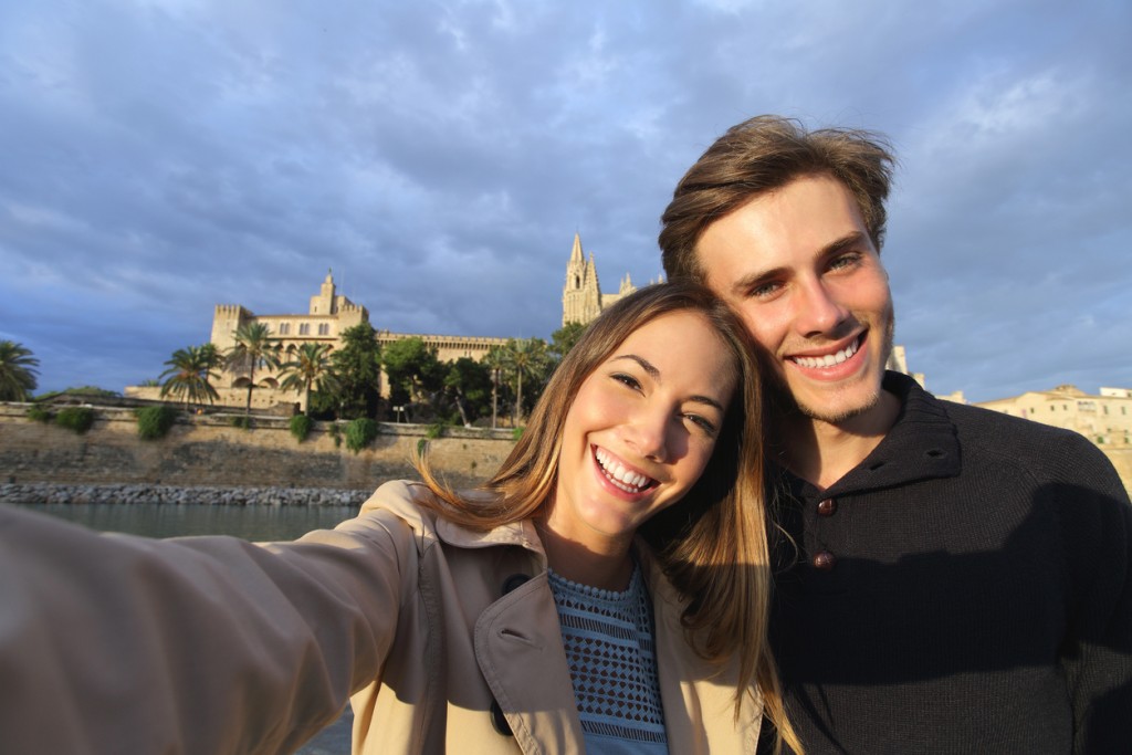 Tourist couple on holidays photographing a selfie