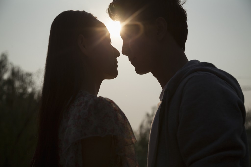 Silhouette of young couple very close to each other