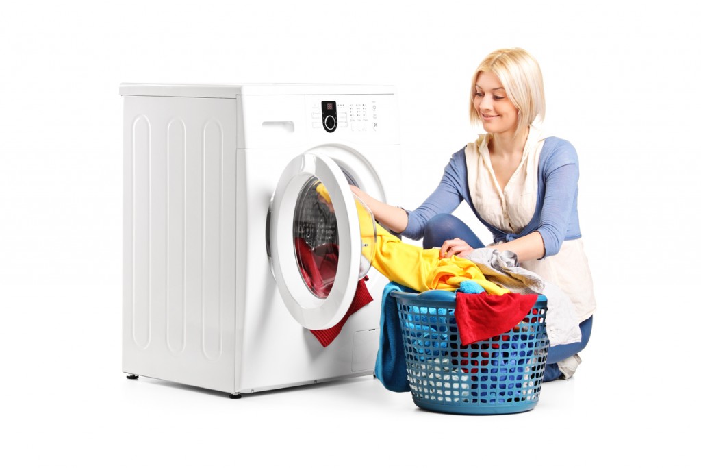 Woman emptying a washing machine