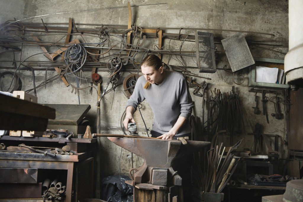 Blacksmith Working In Workshop