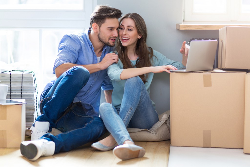 Couple on floor next to moving boxes