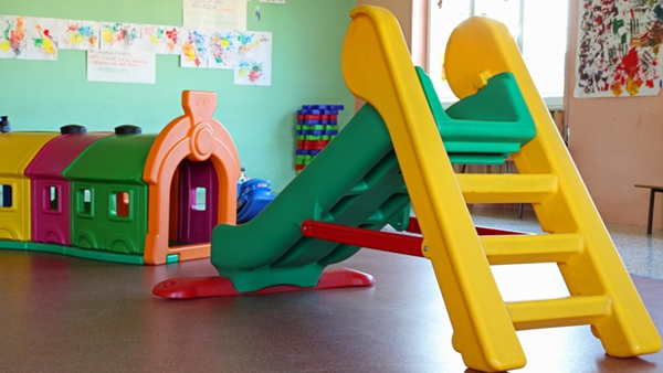A colorful plastic slide and tunnel in playroom