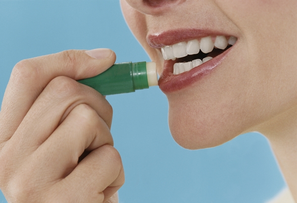 Close-Up of a Woman Applying Lip Balm