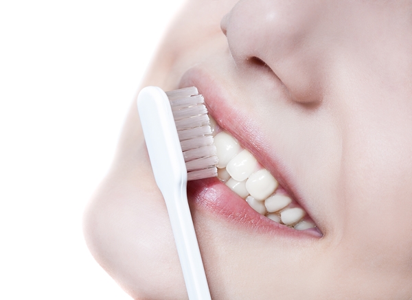 Beautiful woman with toothbrush. Dental care background.