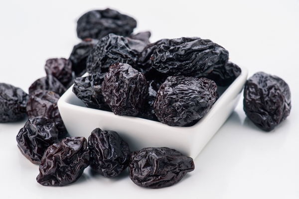 lot of prunes in transparent glass bowl