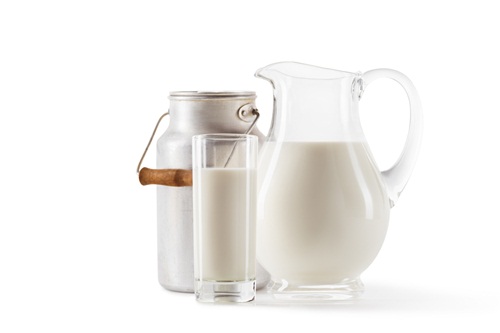 fresh milk in can, jug and glass isolated on white