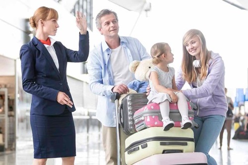 Flight-attendant-guiding-family-at-the-airport