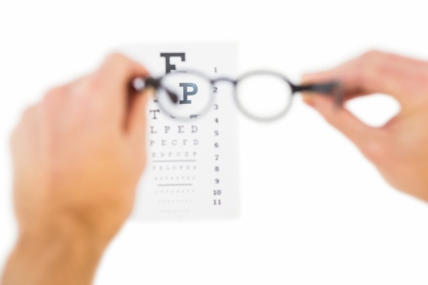 Glasses held up to read eye test