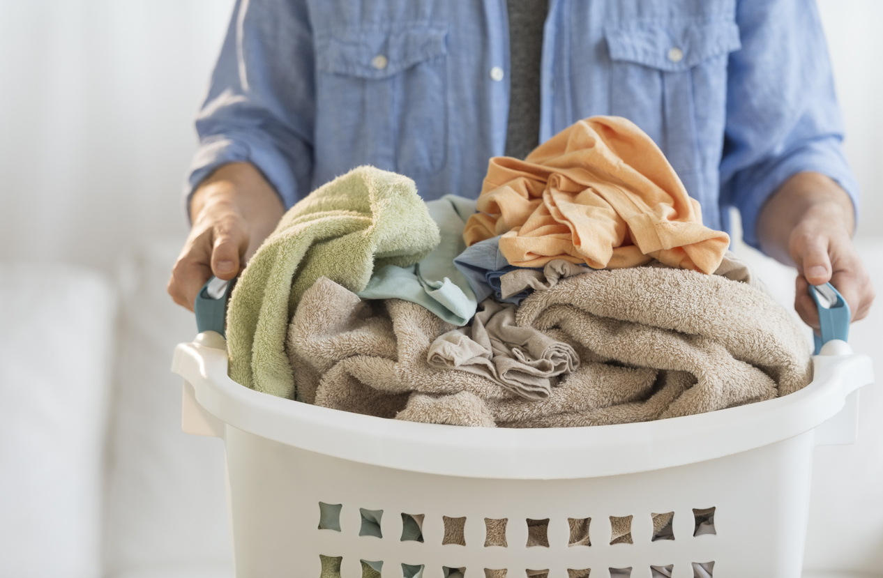 Man Holding Laundry Basket At Home
