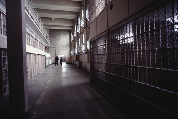 Corridor in Alcatraz prison, two people in background, San Francisco, California, USA