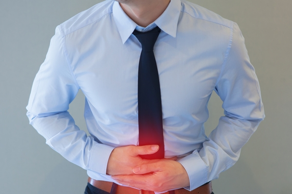 Man in office uniform having a stomachache